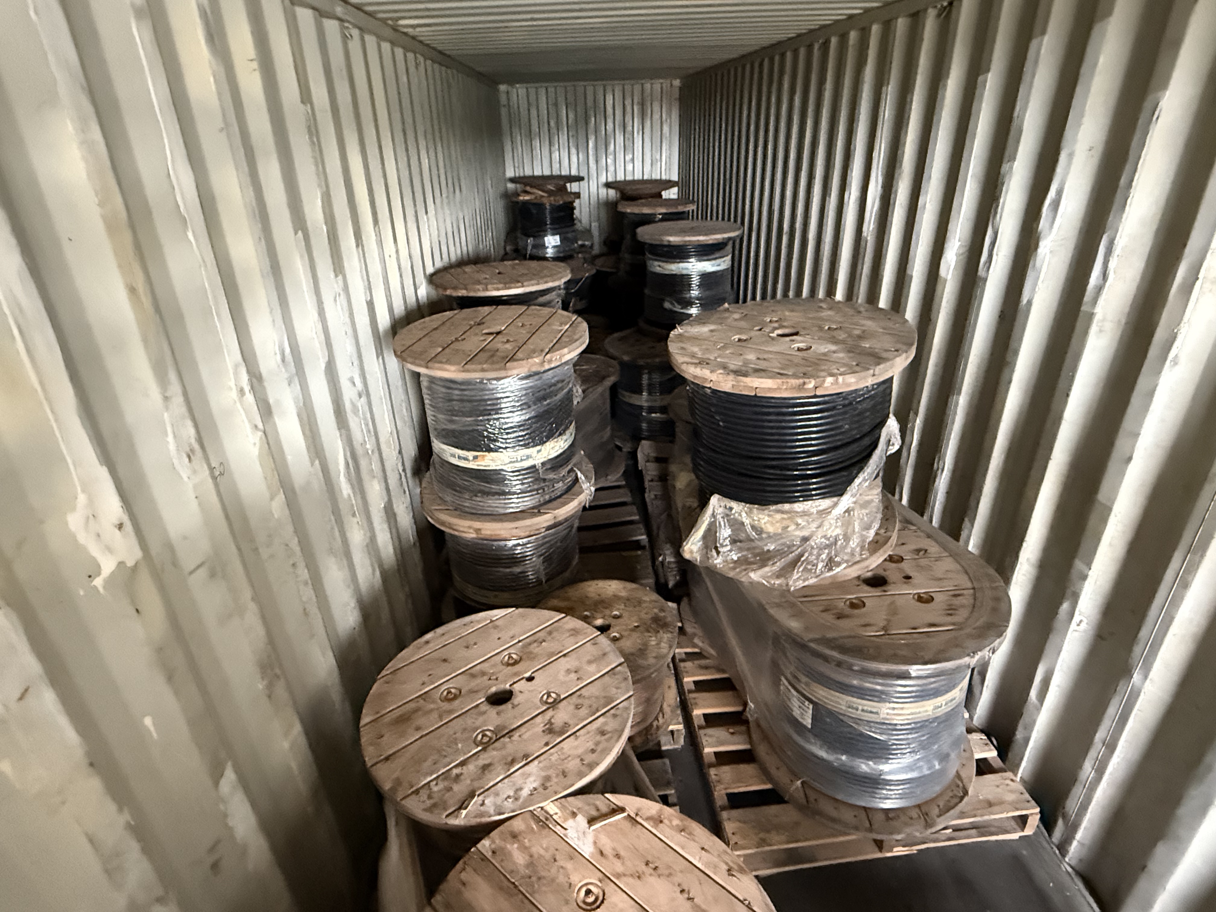Labeled reels and packaged project-surplus electrical cable staged for inventory review
